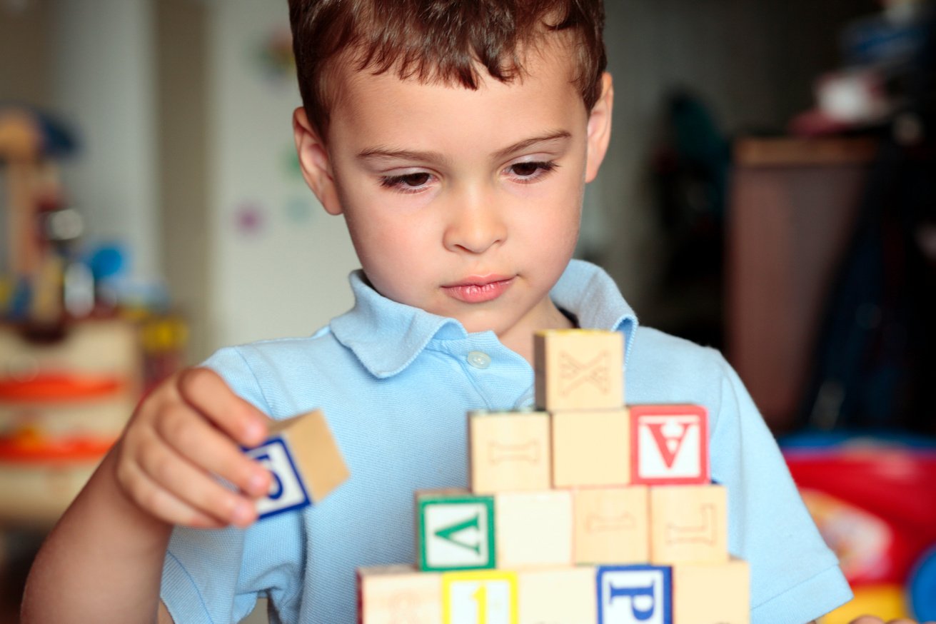 Autistic boy building with blocks